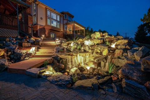 Waterfall below a house deck at dusk