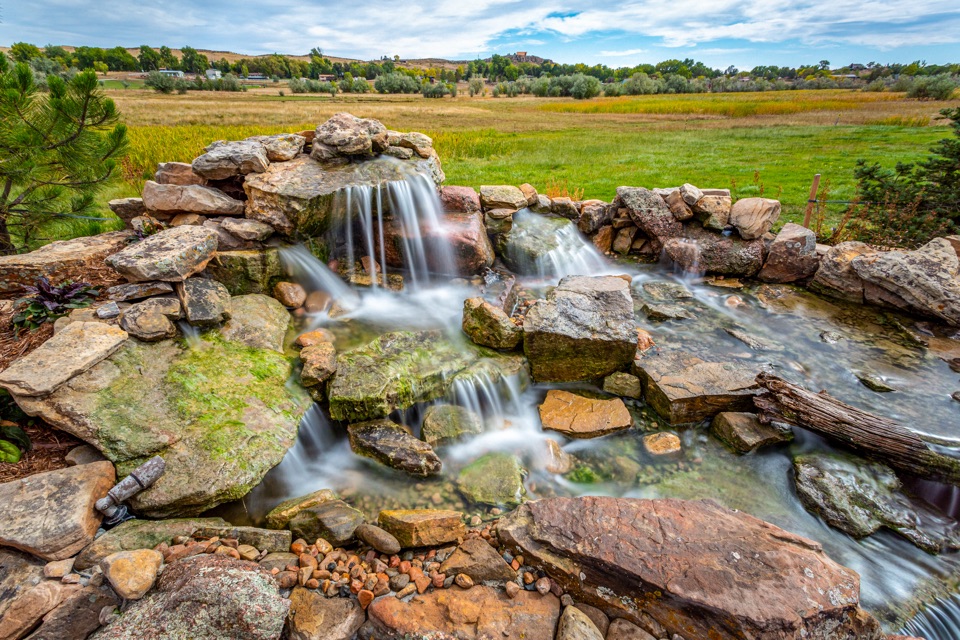 Long-exposure waterfall with prairie behind