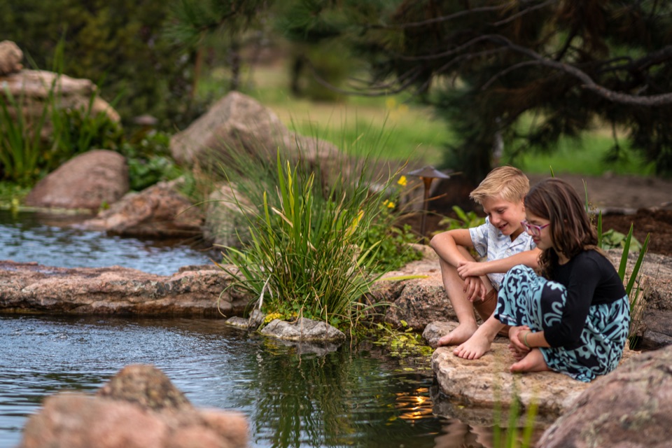 Two children at a pond edge