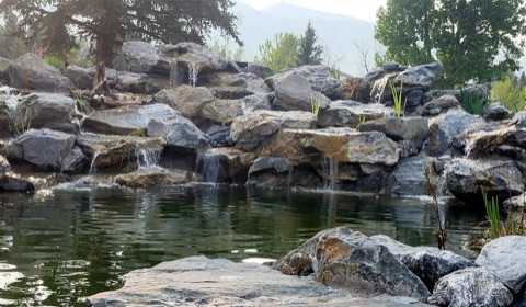 Boulder waterfall into pond