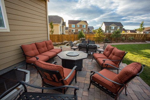 Patio with fire bowl and cushioned chairs
