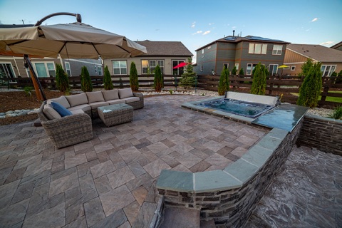Paver patio with hot tub, twilight