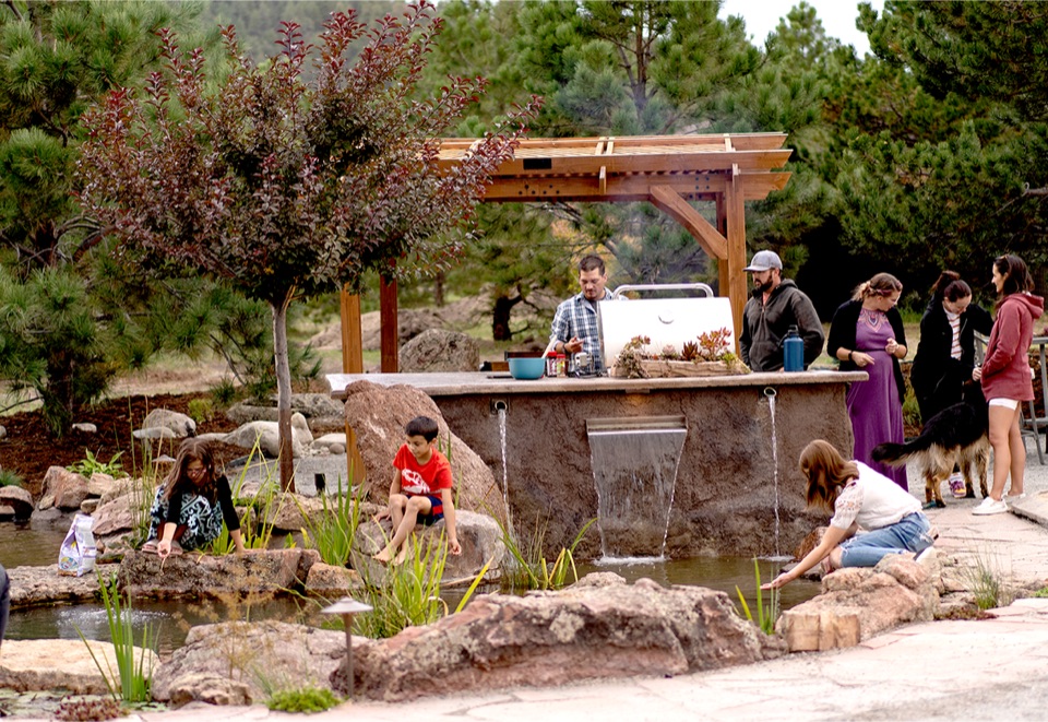 Outdoor kitchen party with kids at the stream