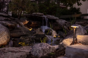 Lit pond edge with path light