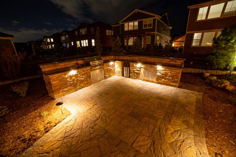 Lit patio with seat wall at twilight