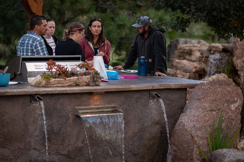 Kitchen with water-wall spillway and guests
